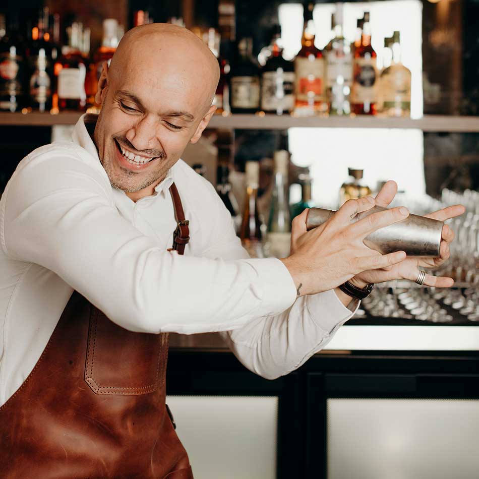 Allara Learning trainer shaking a cocktail shaker