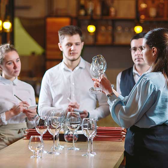 a group of students learning about different types of wine glasses